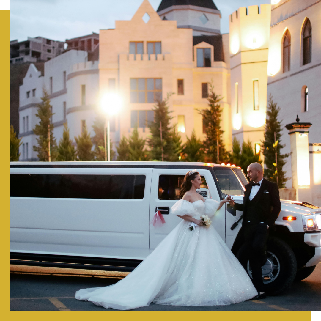 A newly wed couple next to a limo